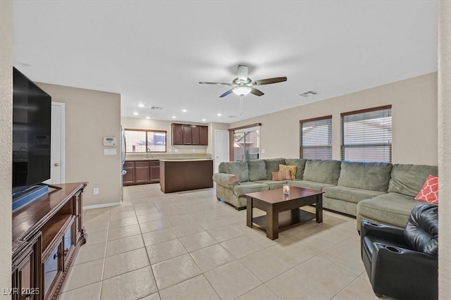 living room with light tile patterned floors, recessed lighting, visible vents, a ceiling fan, and baseboards