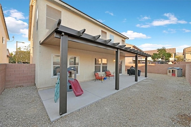 rear view of house with a patio area, a fenced backyard, and stucco siding