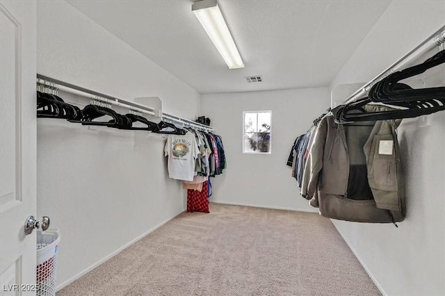 walk in closet with light carpet and visible vents