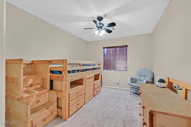 bedroom featuring light carpet, ceiling fan, and baseboards