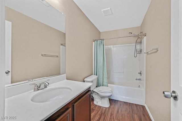 full bath featuring visible vents, toilet, wood finished floors, shower / bath combo with shower curtain, and vanity