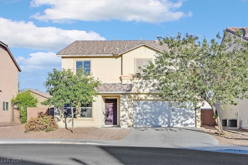 traditional home with cooling unit, concrete driveway, roof with shingles, and stucco siding