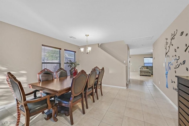 dining area featuring light tile patterned floors, visible vents, a wealth of natural light, and a notable chandelier