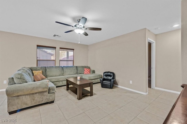 living room with visible vents, baseboards, and light tile patterned floors