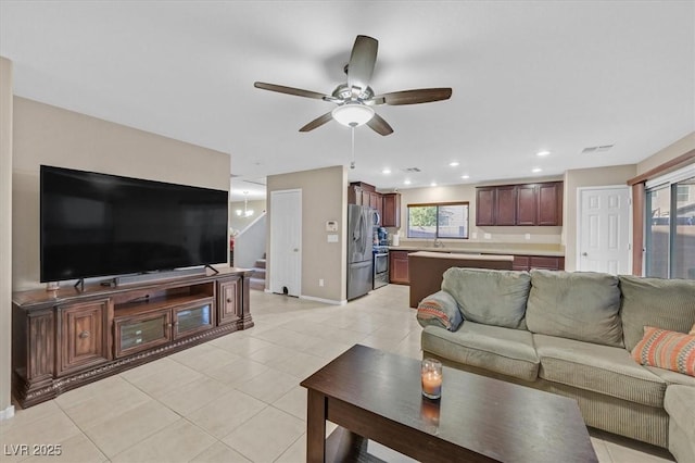 living room featuring light tile patterned floors, recessed lighting, a ceiling fan, visible vents, and stairway