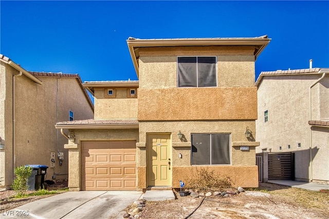 view of front facade featuring a garage, driveway, and stucco siding