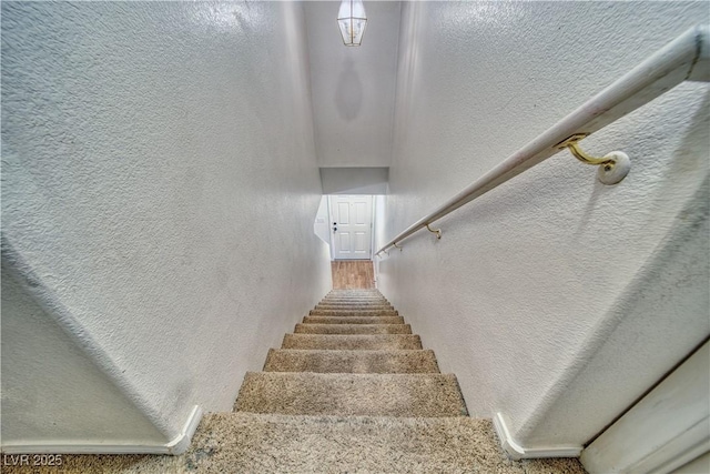 stairs featuring a textured wall