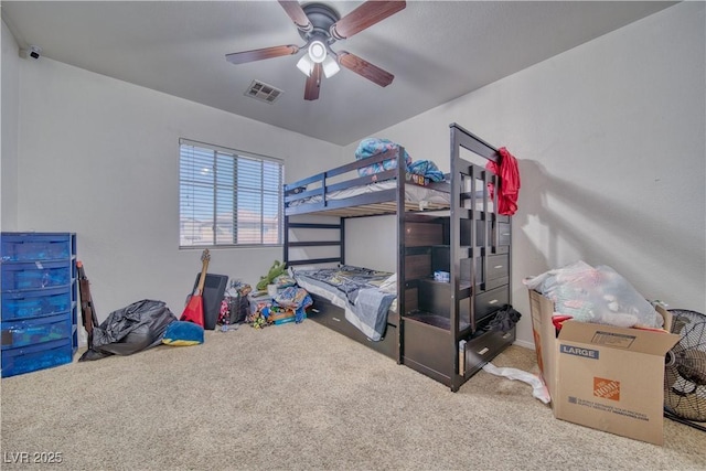 bedroom with visible vents, a ceiling fan, and carpet flooring