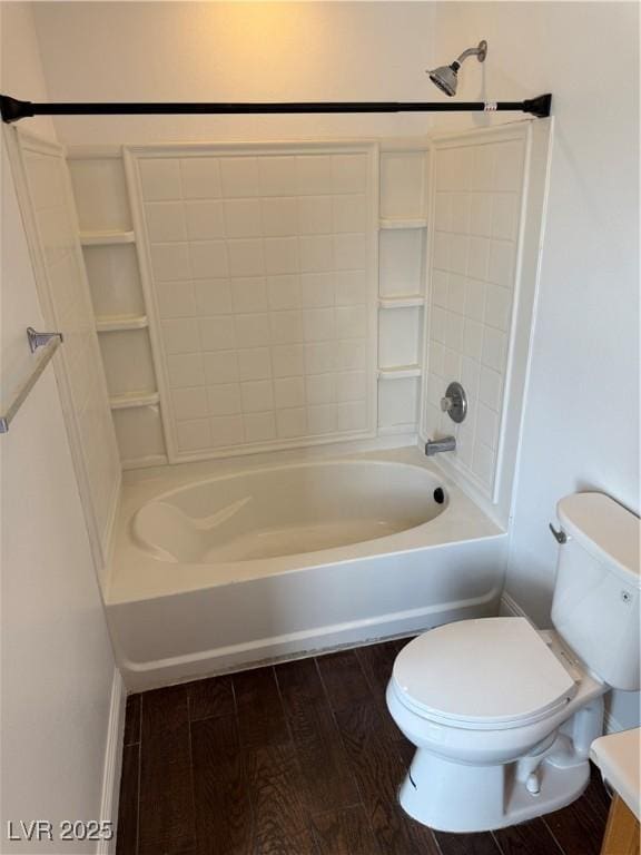 full bathroom with bathing tub / shower combination, wood finished floors, and toilet