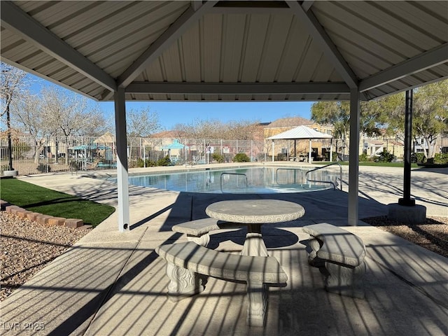 pool with a residential view, fence, a gazebo, and a patio