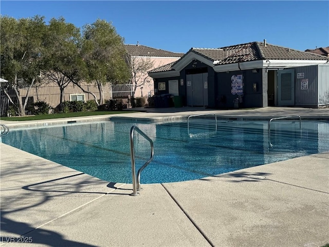 community pool with fence and a patio