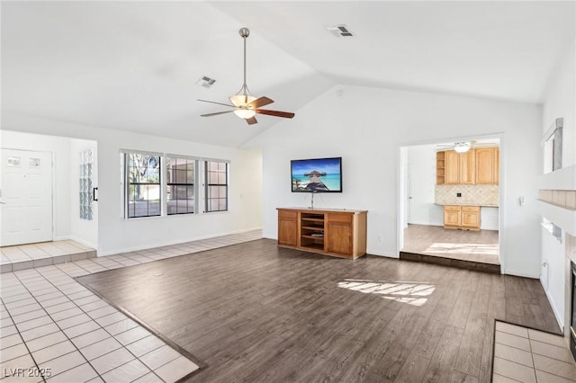 unfurnished living room with ceiling fan, dark wood-style flooring, a fireplace, and visible vents