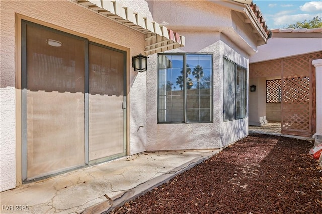 view of exterior entry with stucco siding