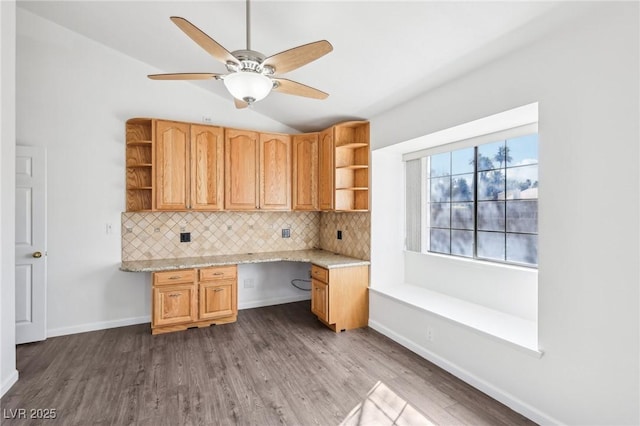 kitchen with open shelves, built in desk, wood finished floors, and decorative backsplash