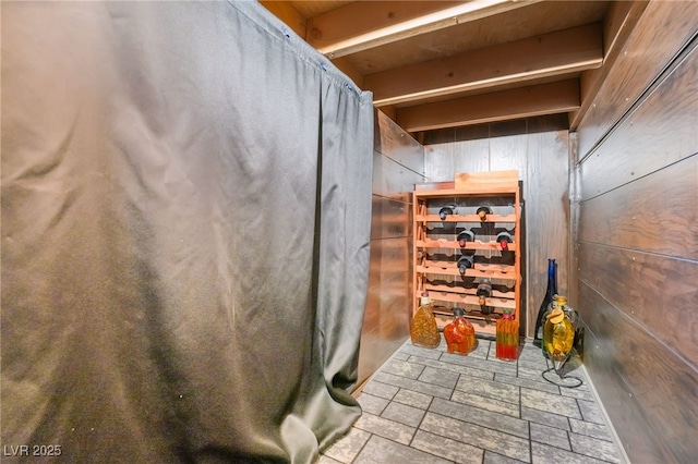 interior space with stone finish flooring and wood walls