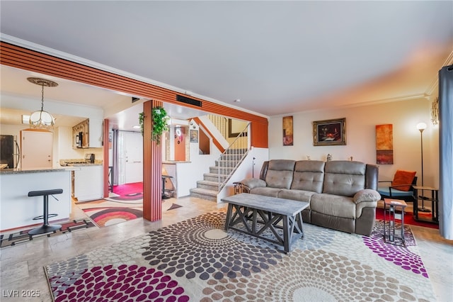 living area with stairway and crown molding