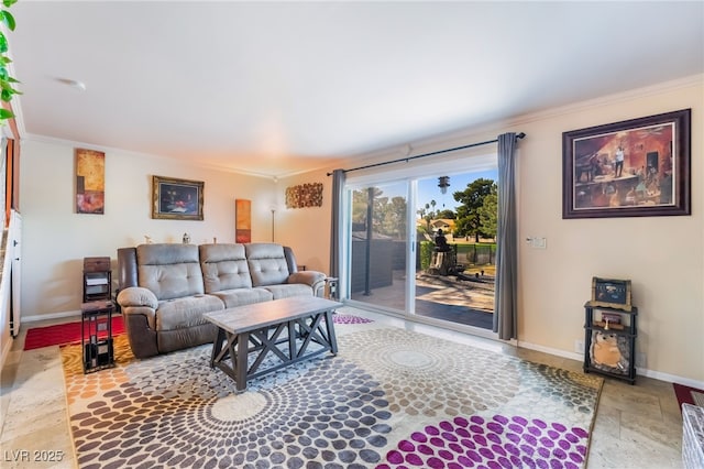 living area with stone finish flooring, ornamental molding, and baseboards