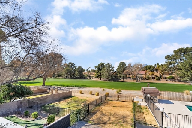 view of community with a gate, fence, and a lawn