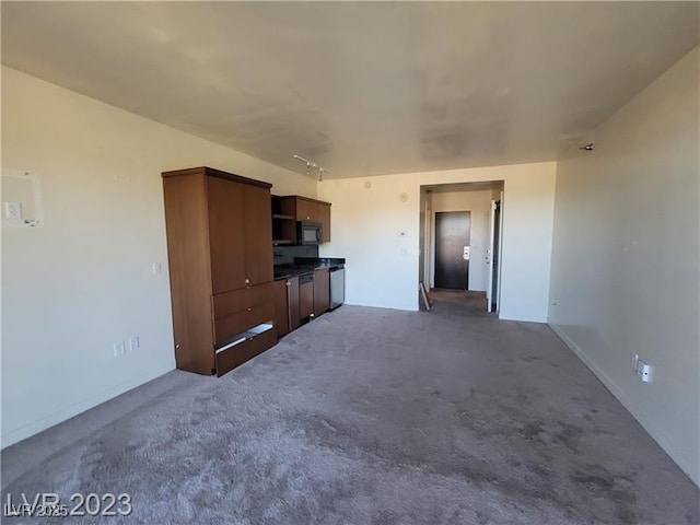 unfurnished living room with dark carpet