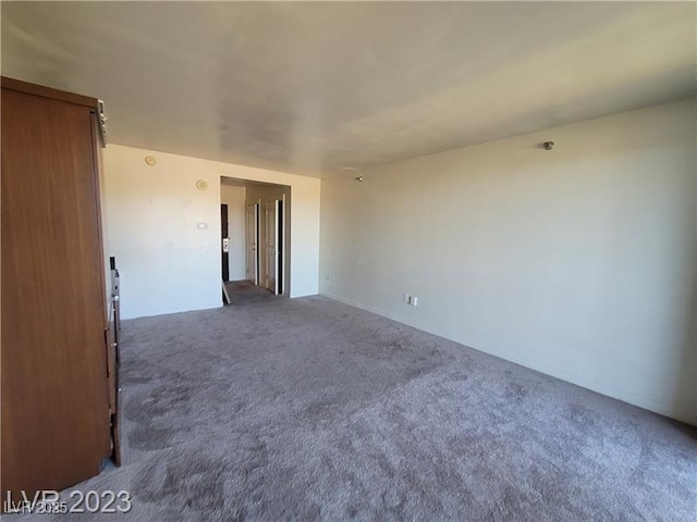 empty room with dark colored carpet