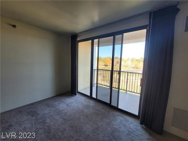 carpeted empty room with visible vents