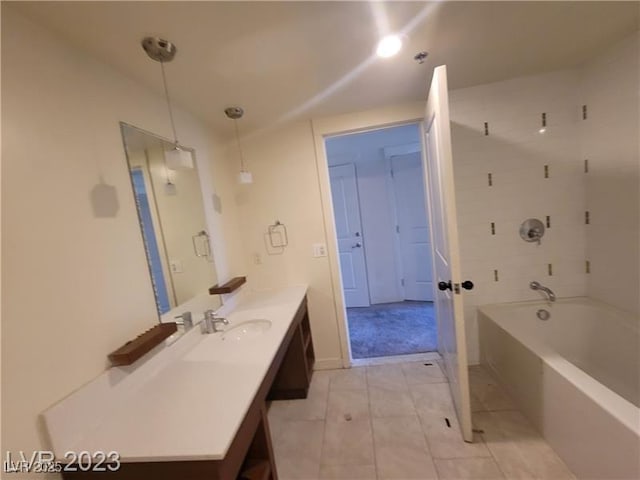 bathroom with bathing tub / shower combination, tile patterned flooring, and vanity