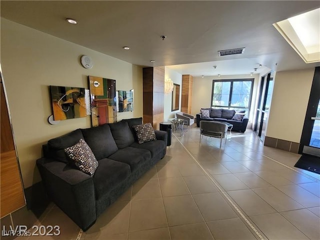 living area featuring light tile patterned floors and visible vents