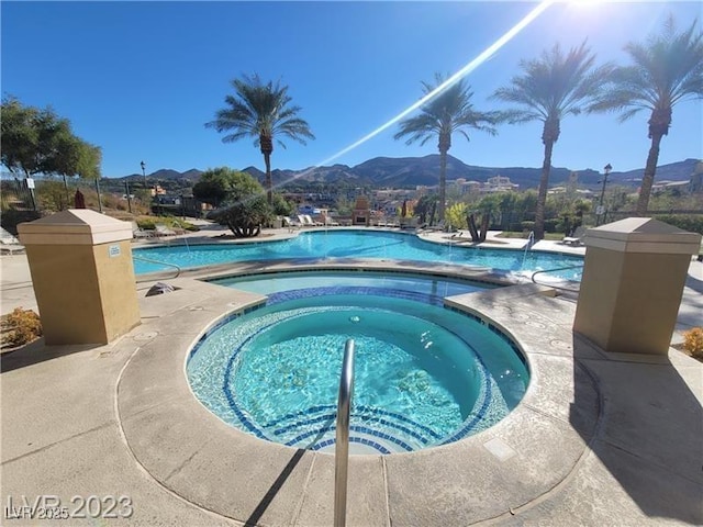 community pool with a community hot tub and a mountain view