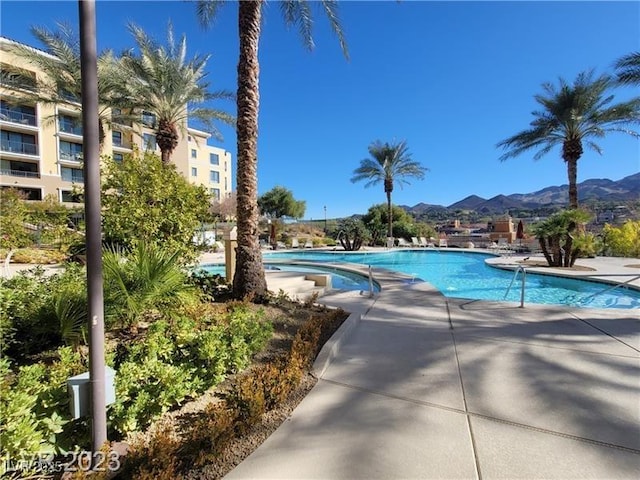 community pool with a mountain view