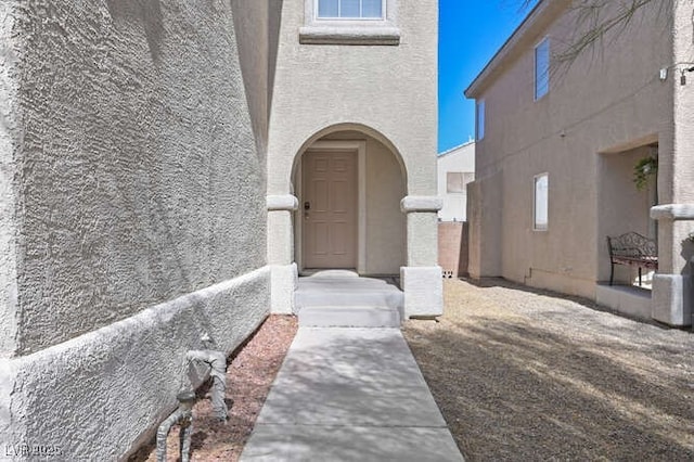 entrance to property with stucco siding