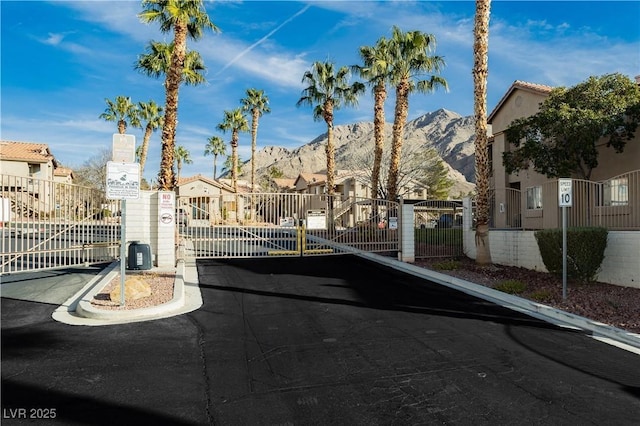 view of street featuring a gated entry, a residential view, and a gate