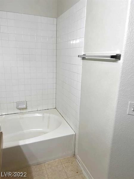 full bathroom featuring a washtub and tile patterned floors