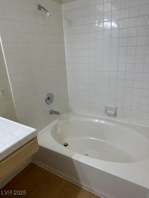 bathroom featuring shower / bathtub combination and wood finished floors