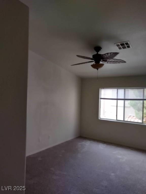 carpeted spare room with ceiling fan and visible vents