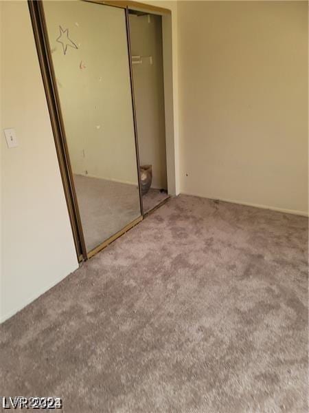 unfurnished bedroom with carpet floors and a closet