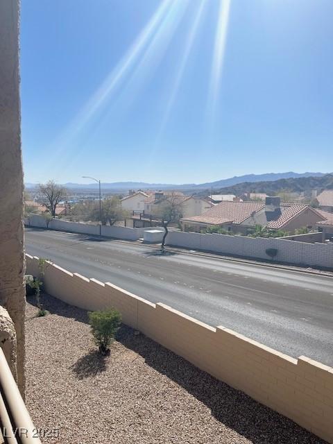 view of street featuring street lights, sidewalks, and a mountain view