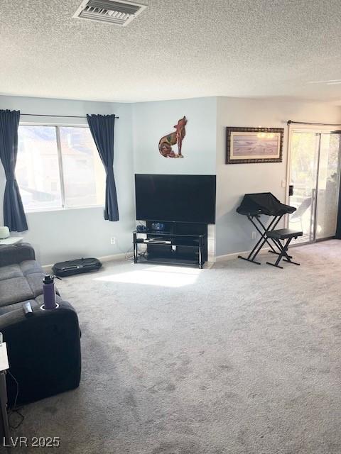2240 Highpointe Dr Unit 201, Laughlin, NV 89029 - carpeted living room featuring a textured ceiling and baseboards