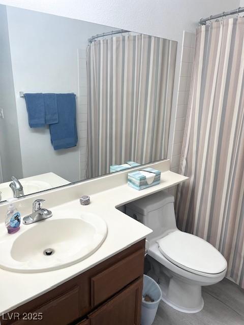 bathroom featuring toilet and vanity