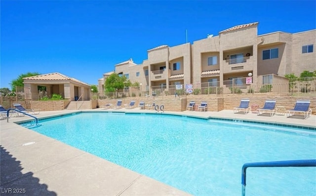 pool featuring a patio area and fence