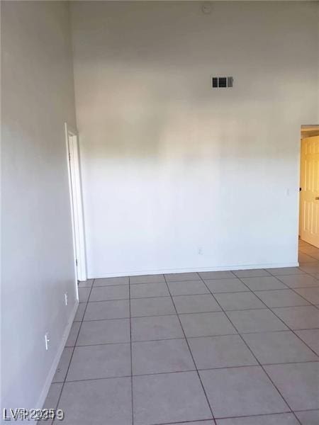 unfurnished room with light tile patterned floors, baseboards, and visible vents