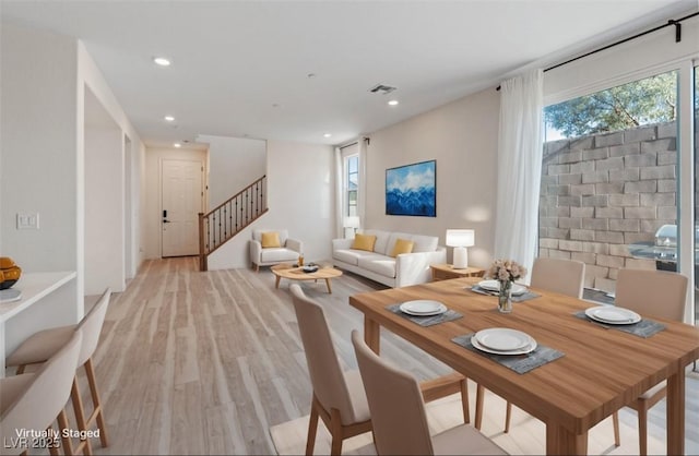 dining space with visible vents, recessed lighting, stairway, and light wood-style floors