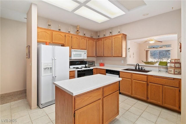 kitchen with white appliances, a sink, a kitchen island, a ceiling fan, and light countertops