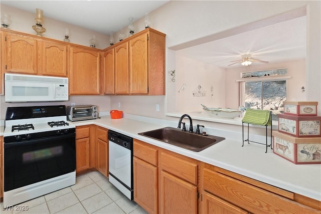 kitchen with range with gas stovetop, light countertops, white microwave, a sink, and dishwasher