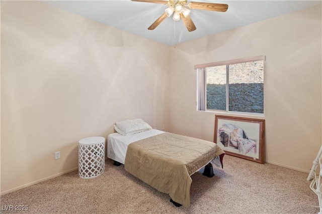 bedroom featuring baseboards, ceiling fan, and light colored carpet