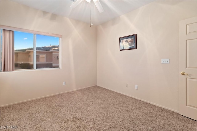 empty room featuring carpet and baseboards