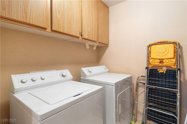 laundry area featuring separate washer and dryer and cabinet space