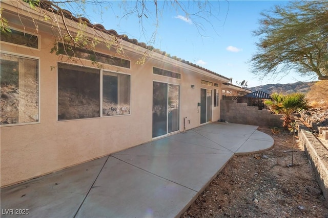 back of property featuring a patio and stucco siding