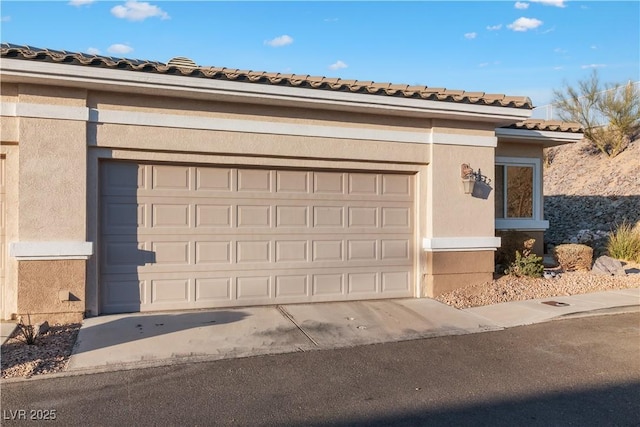 garage with concrete driveway