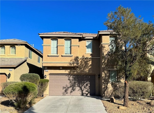 view of front of property with driveway, a garage, and stucco siding