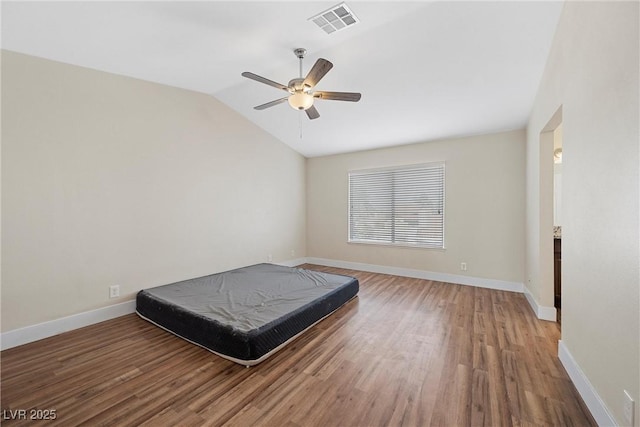 bedroom featuring lofted ceiling, light wood-style flooring, visible vents, and baseboards